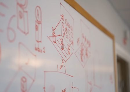 a-whiteboard-covered-in-drawings-and-diagrams-with-a-quake-logo-on-the-left-half-of-the-board.jpg