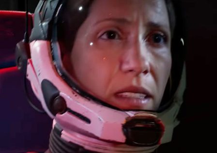 Returnal-trailer-screenshot-showing-Selene-a-female-astronaut-in-a-space-suit-and-helmet-looking-concerned-as-her-craft-crashes.jpg