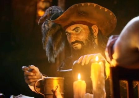 Assassins-Creed-Black-Flag-screenshot-showing-a-male-with-a-beard-and-fancy-hat-pouring-himself-a-drink-at-a-candle-lit-table.jpg