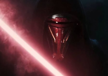 a-close-up-of-revan-in-the-kotor-remake-reveal-trailer-they-are-wearing-a-mask-that-covers-their-entire-face-and-a-black-hood-they-are-also-holding-a-red-lightsaber.png